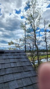 Antenna mast standing above the roof ridge, seen from the roof